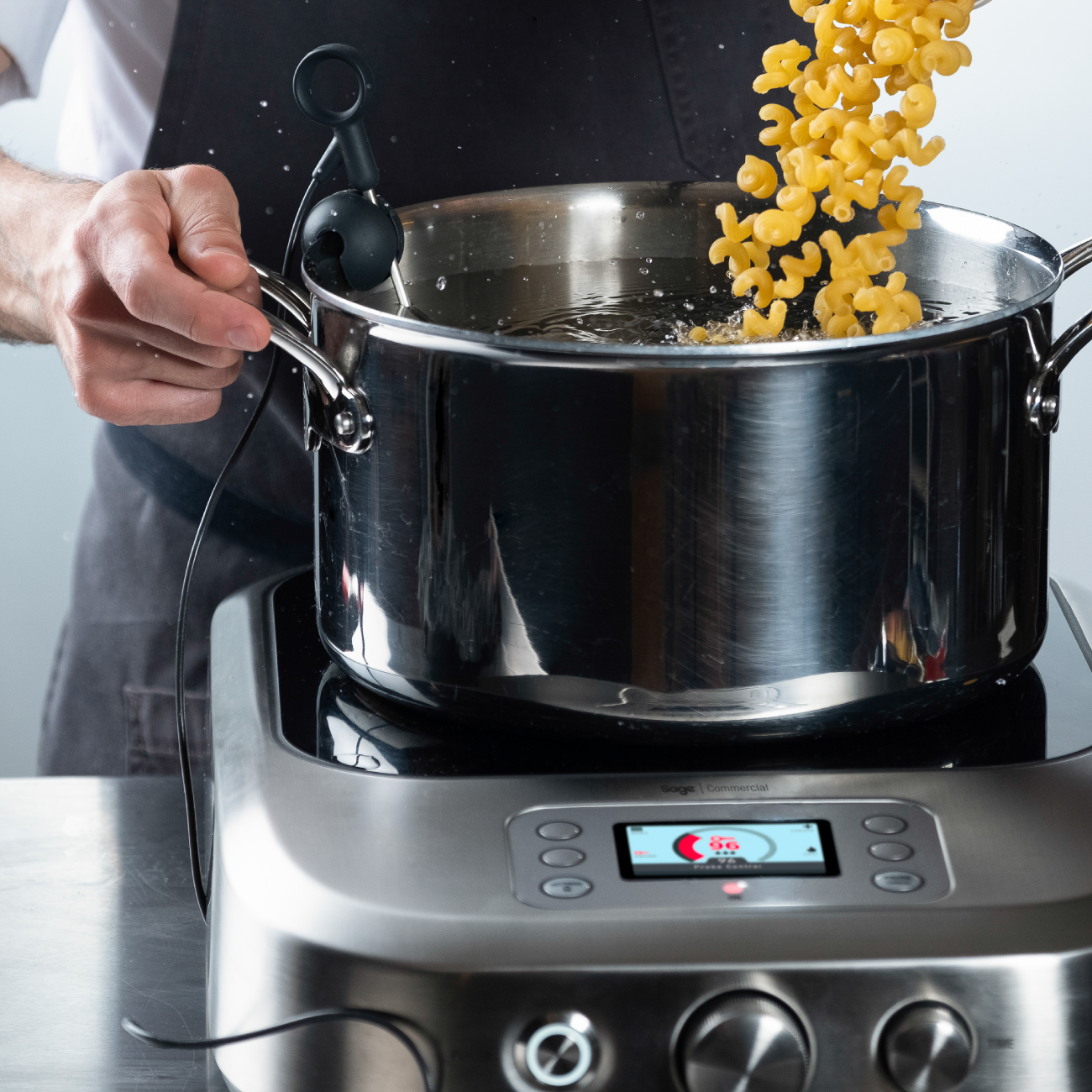 Person adjusting temperature dial of the precision cooker.