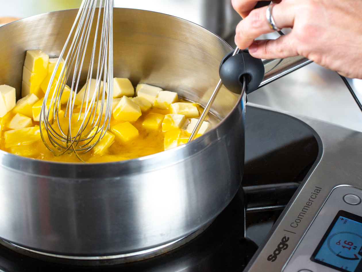 The probe measures the temperature of butter melting in a pot on top of the precision cooker.