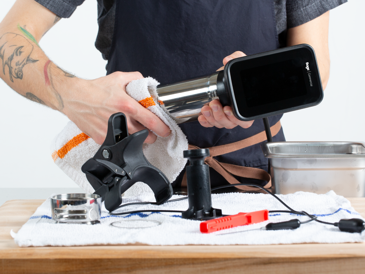 A person cleans the cylindrical component of the HydroPro™ with a cloth.