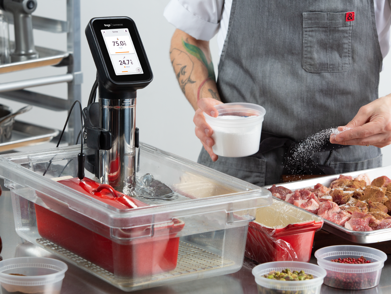 The HydroPro™ is immersed in a body of water while the chef seasons the meat.