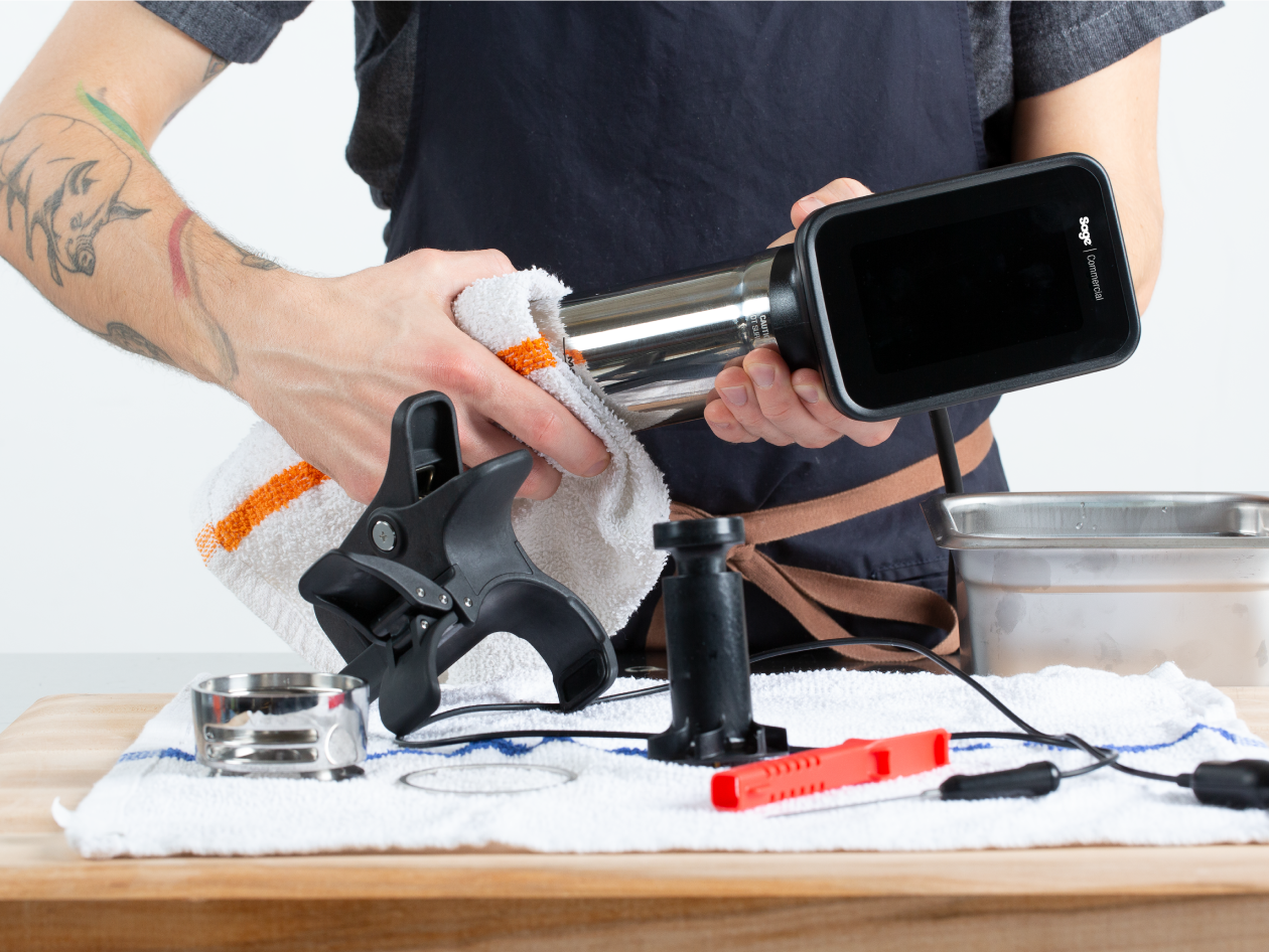 A person cleans the cylindrical component of the HydroPro™ Plus with a cloth.